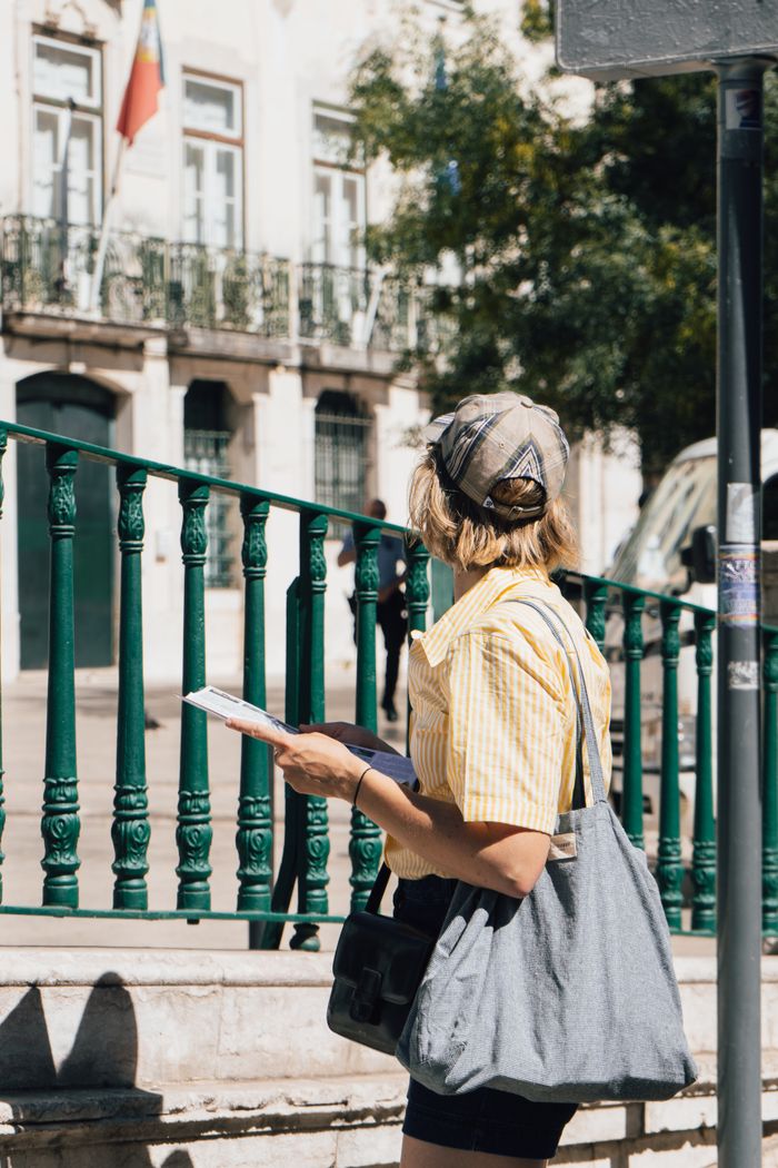 A traveller with a map on a bright Lisbon street
