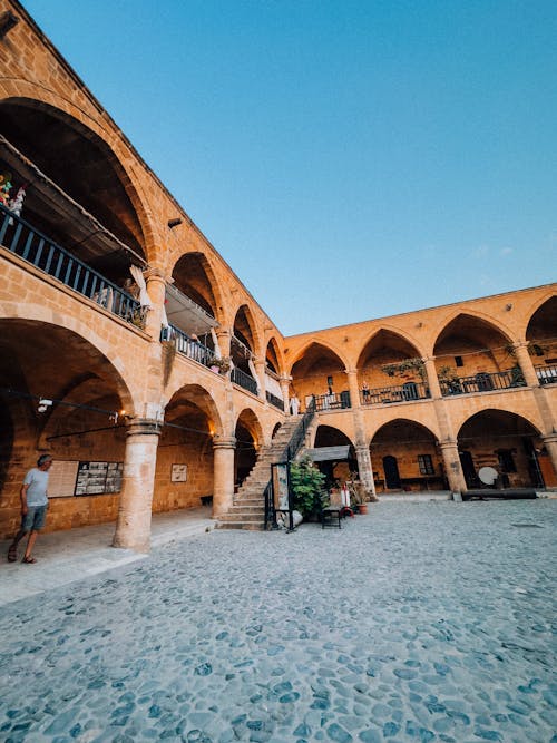 The courtyard of an old building with arches