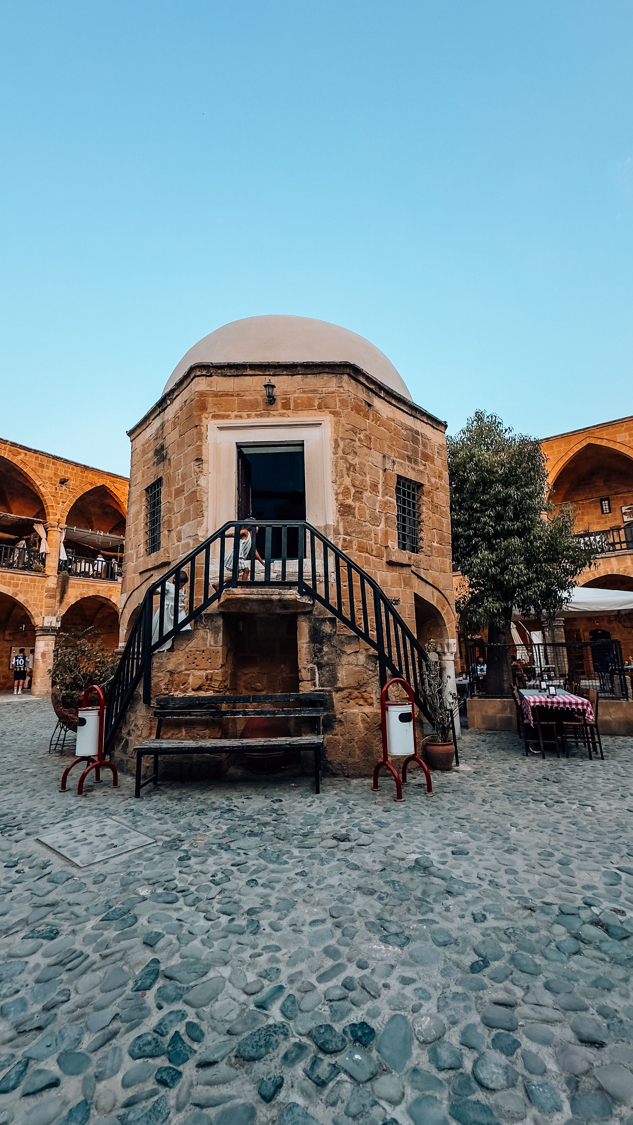 Explore the beautiful Buyuk Han courtyard, Nicosia's famous Ottoman caravanserai in Cyprus.
