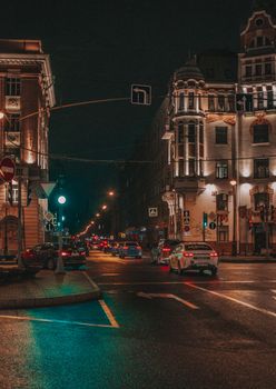 Night street scene in Saint Petersburg showcasing classic architecture and city lights.