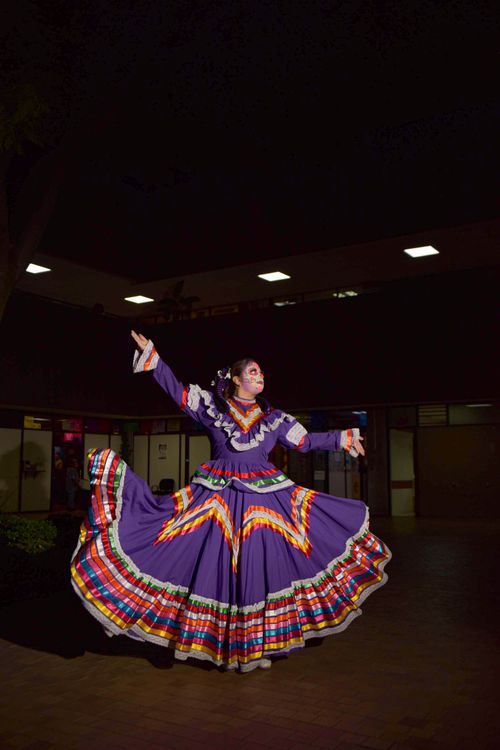 Free Mexican woman in colorful traditional dress performs a Dia de Muertos dance. Stock Photo