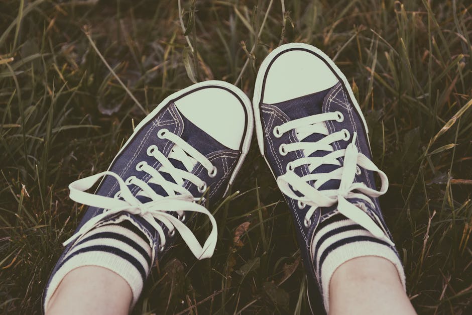 Person Showing Its Feet Wearing White Sneakers · Free Stock Photo