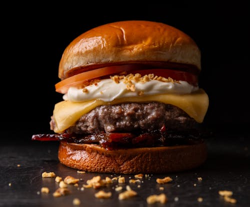 Free A hamburger with cheese, bacon and tomato Stock Photo