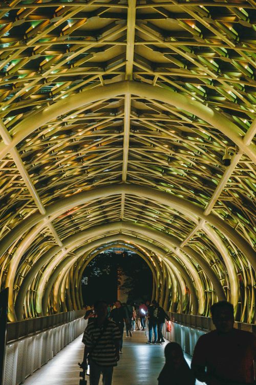 Free People walking through the stunning Saloma Link Bridge illuminated at night in Kuala Lumpur, Malaysia. Stock Photo