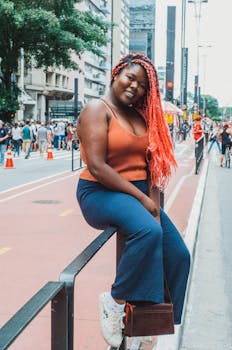 A stylish young woman poses confidently in a vibrant urban street, showcasing modern fashion in Sao Paulo.