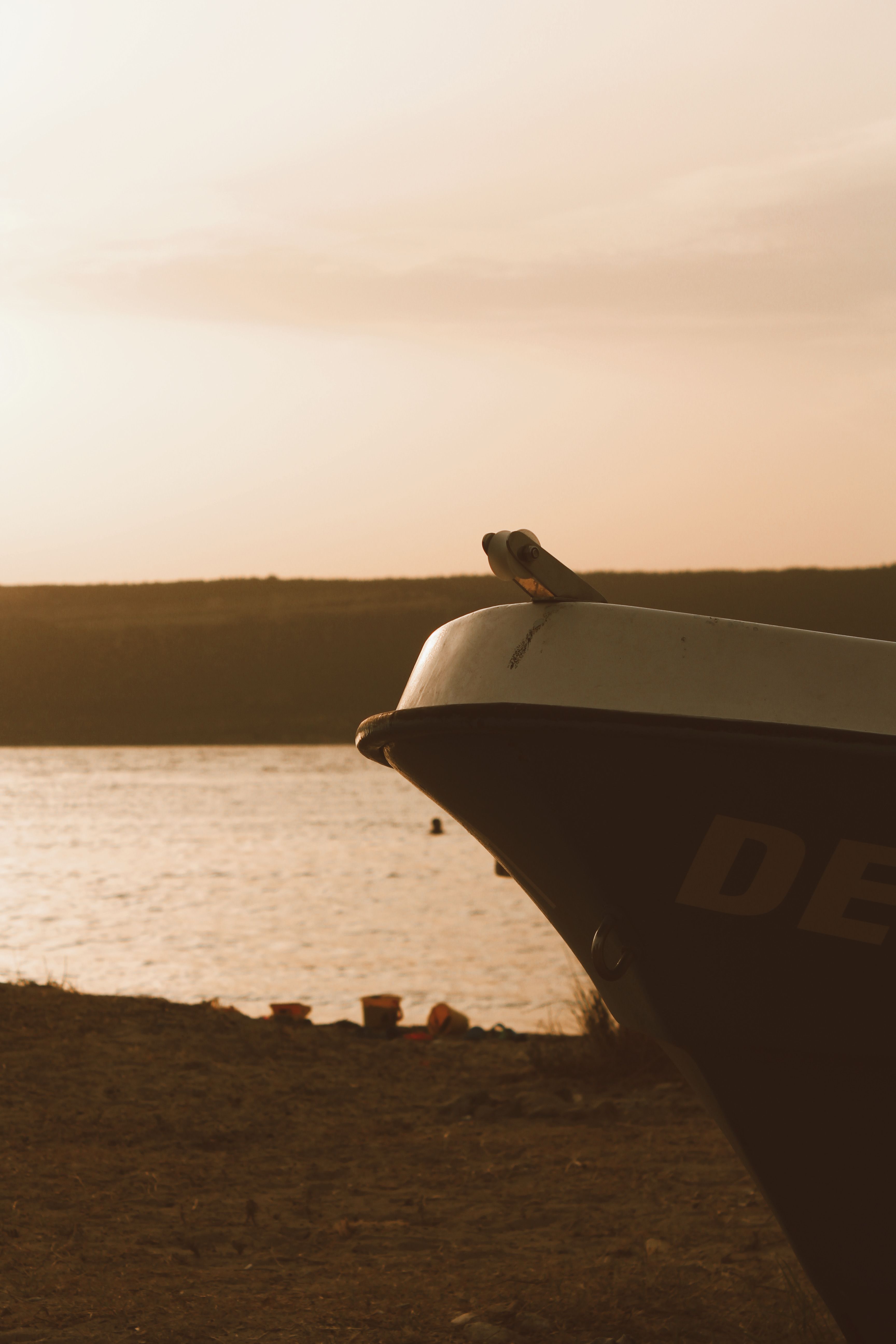 A Boat Standing on the Beach at Sunset · Free Stock Photo