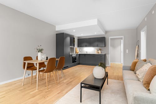 A modern living room with a dining table and chairs