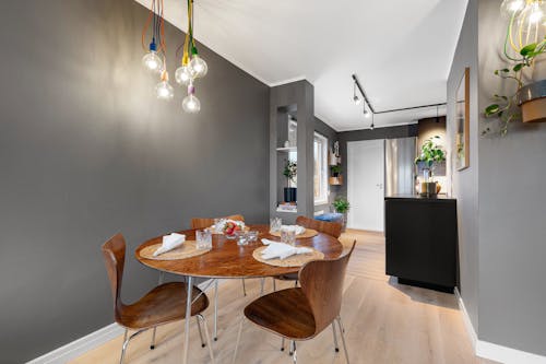 A dining room with wooden floors and a table