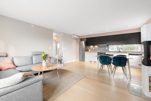 A living room with a fireplace and a kitchen