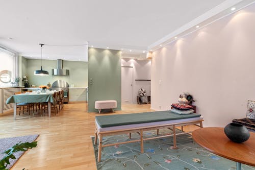 A living room with a green floor and pink walls