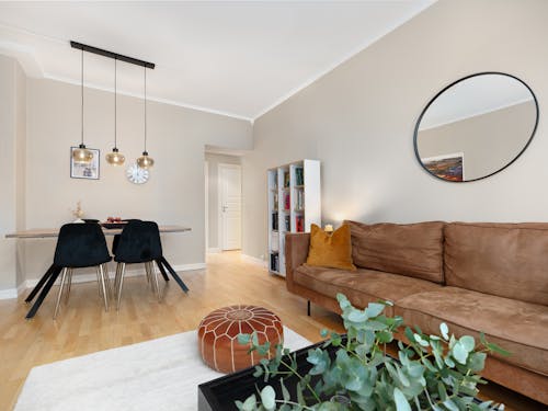 A living room with a couch, table and chairs