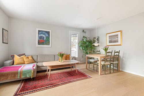 A living room with a rug, couch and coffee table