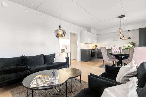 A living room with black furniture and a white couch