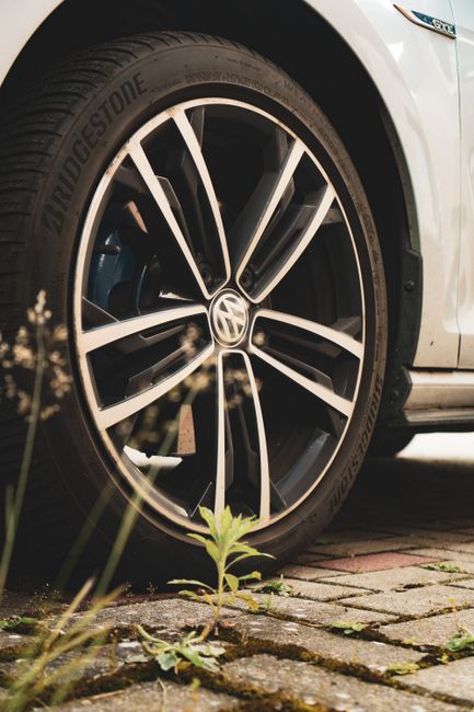 Detailed image of a Bridgestone tire and Volkswagen alloy wheel on a car.