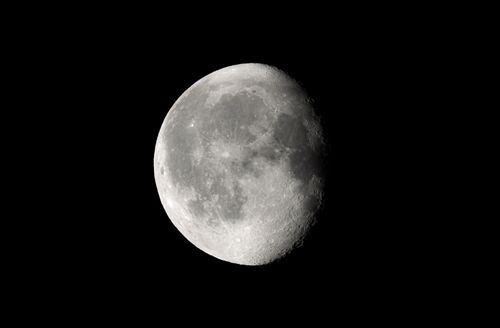 Free Waning gibbous moon captured against a deep black sky in Darien, CT. Stock Photo