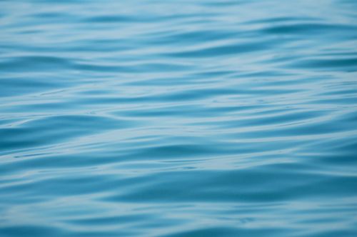 Free A serene close-up of a calm blue ocean surface with gentle ripples, capturing tranquility. Stock Photo