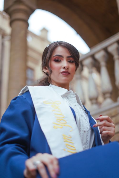 Free Graduate posing elegantly in Baghdad, showcasing academic success. Stock Photo