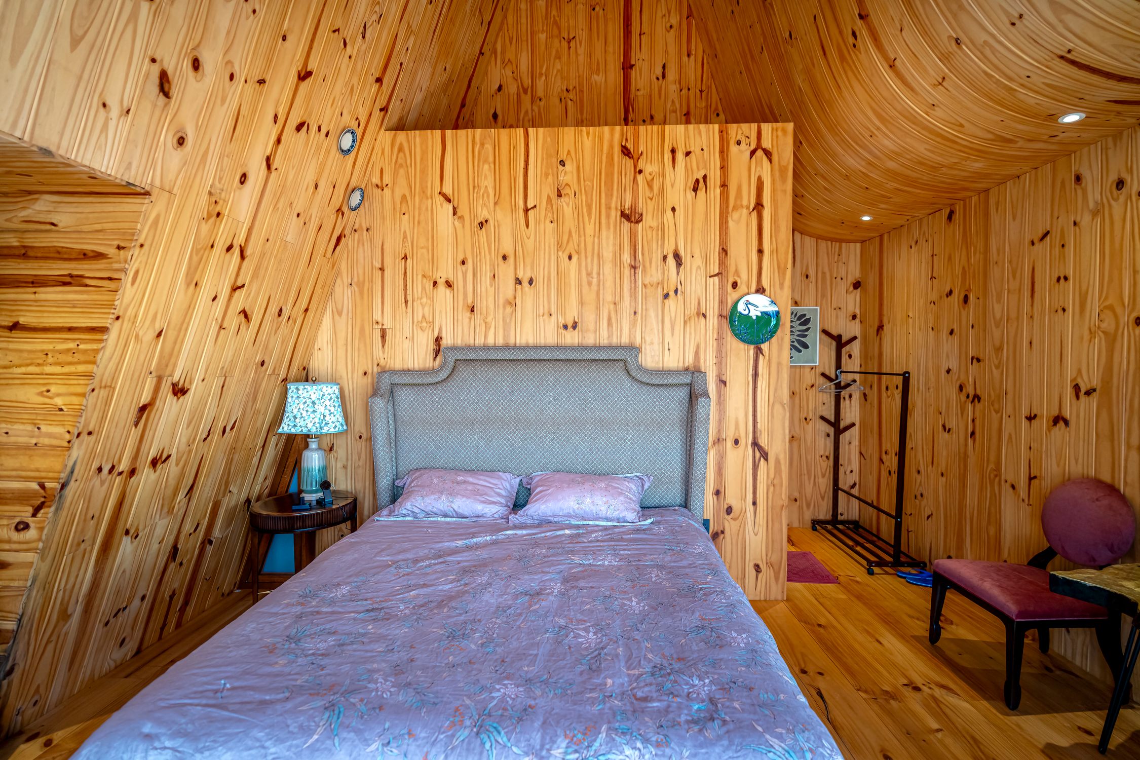 Warm wooden bedroom with vintage decor and elegant touches, perfect for a cozy retreat.