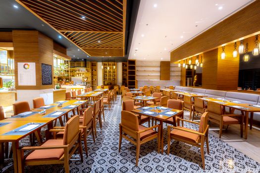 Elegantly designed restaurant with stylish furniture and ambient lighting, ideal for dining.