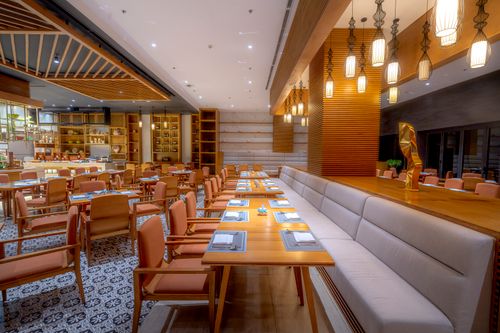 Free Luxurious modern restaurant interior featuring warm lighting and minimalist design. Stock Photo