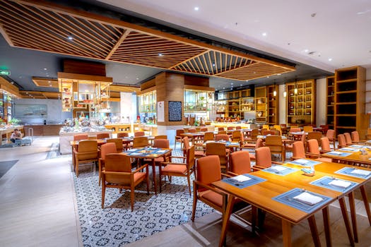 Spacious modern restaurant interior with luxury tables and chairs, perfect for fine dining.