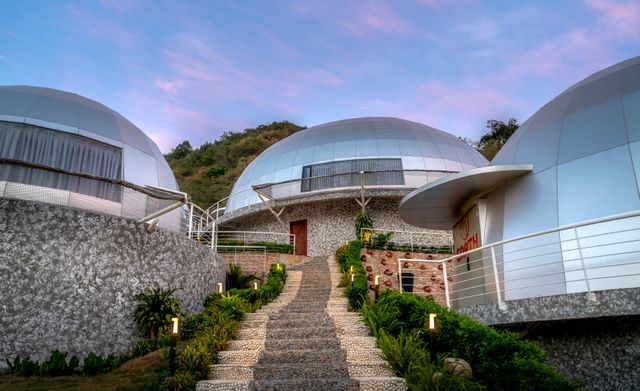 Explore modern architecture at a dome-style resort in Vietnam, showcasing innovative design and tranquil surroundings. Related image for Sustainability: How Brands Can Improve Performance.