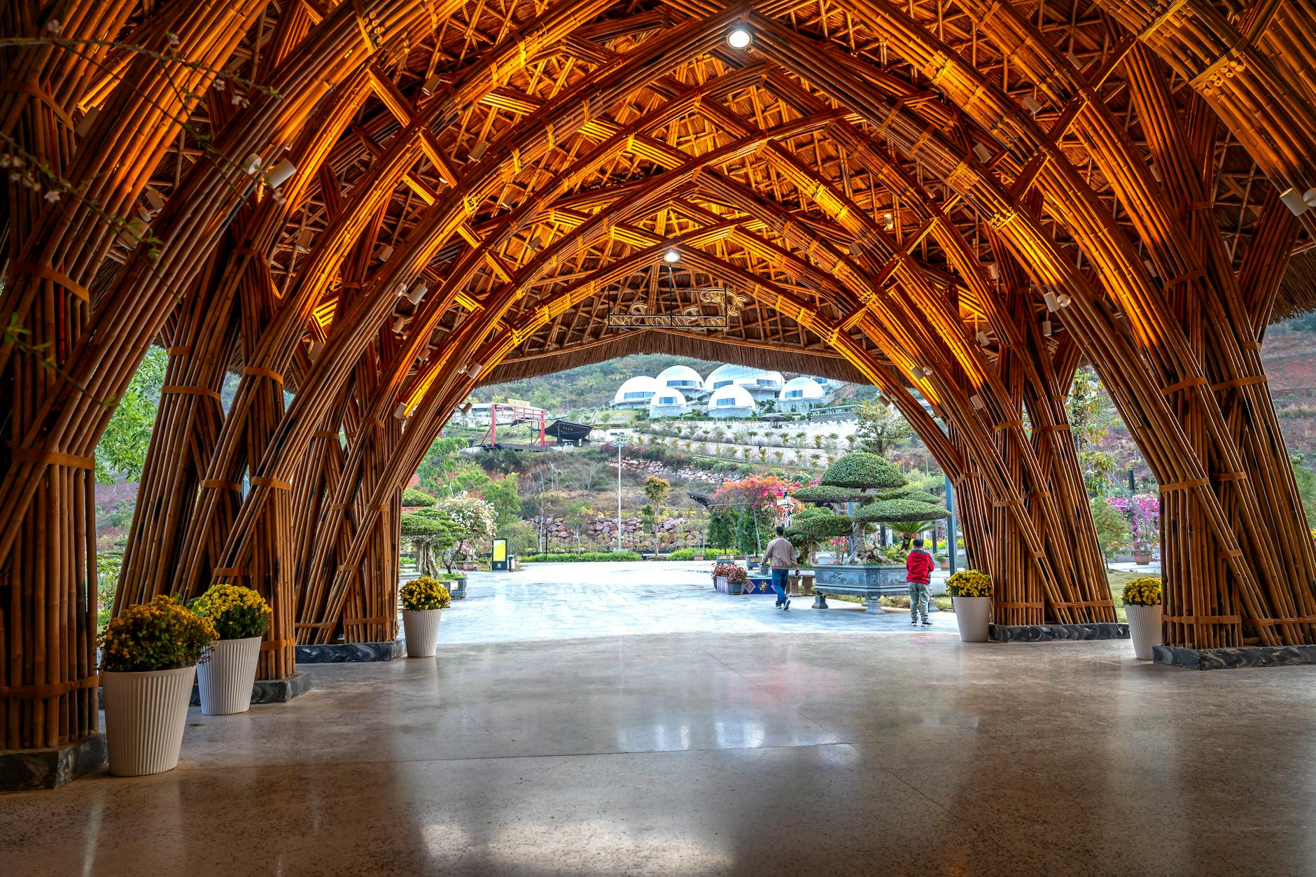 Stunning bamboo archway at a luxury resort in Vietnam with a view of the surrounding landscape.