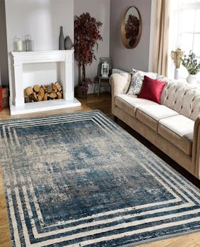 Stylish living room featuring a modern fireplace, plush sofa, and patterned carpet.