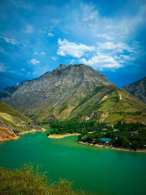 Free Explore the stunning landscape of Lake Charvak with its turquoise waters and towering mountains under a bright blue sky. Stock Photo