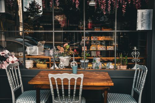 Free Quaint café setup with wooden table and chairs, plants, and decor in Taşova, Amasya, Türkiye. Stock Photo