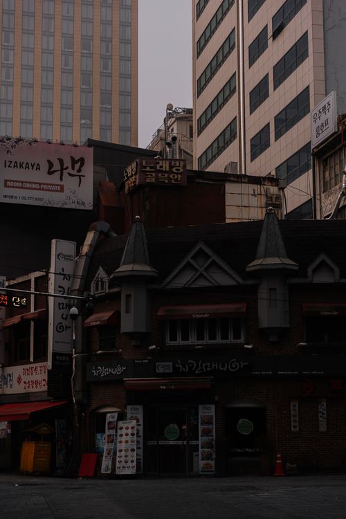 Free Gloomy city evening showcasing historic architecture amidst high rises. Stock Photo