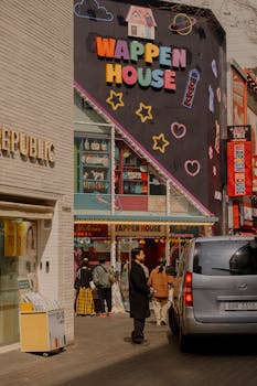 Lively street view outside Wappen House in Seoul with pedestrians and colorful signage.