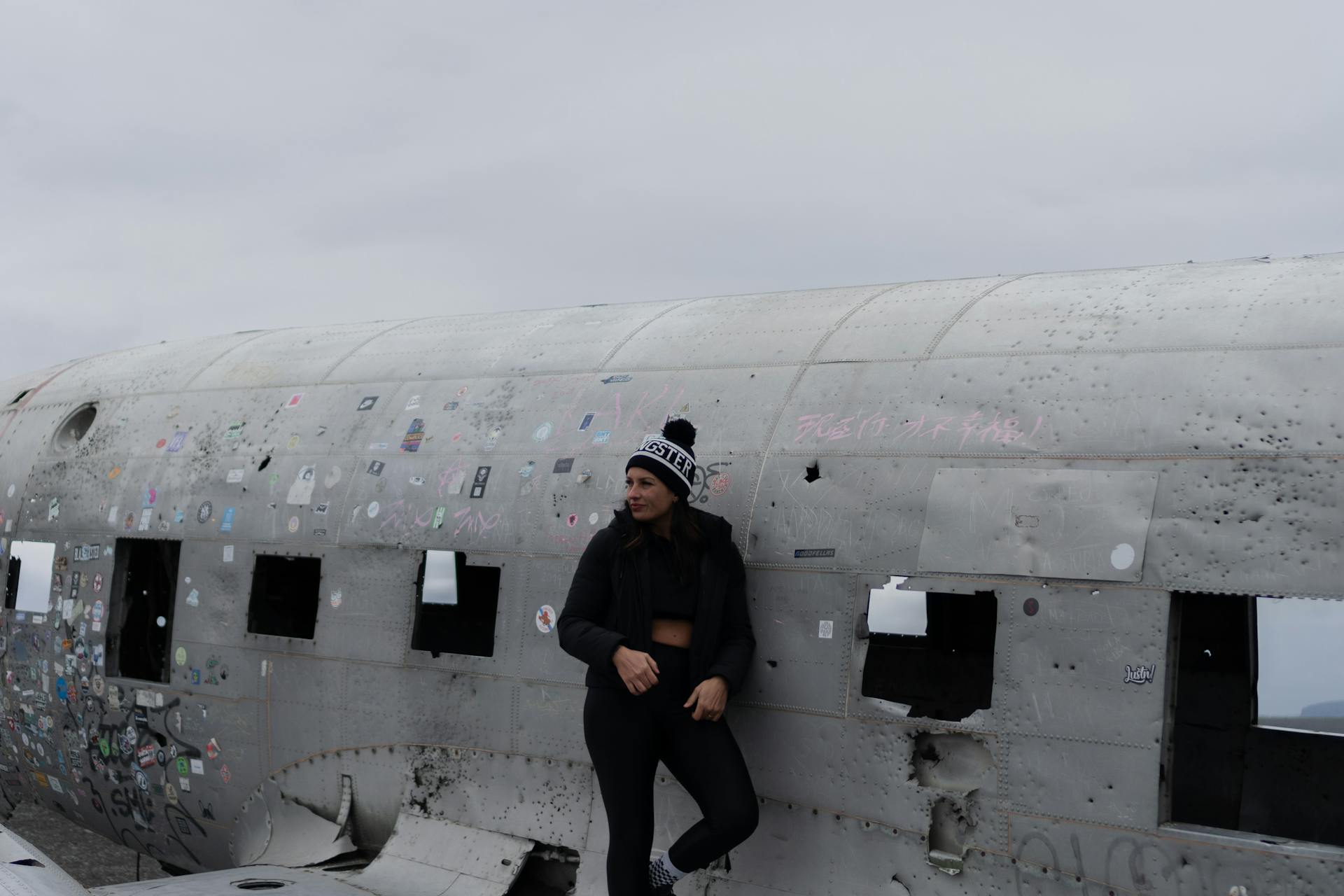 Woman in Jacket Standing on Airplane Wreckage