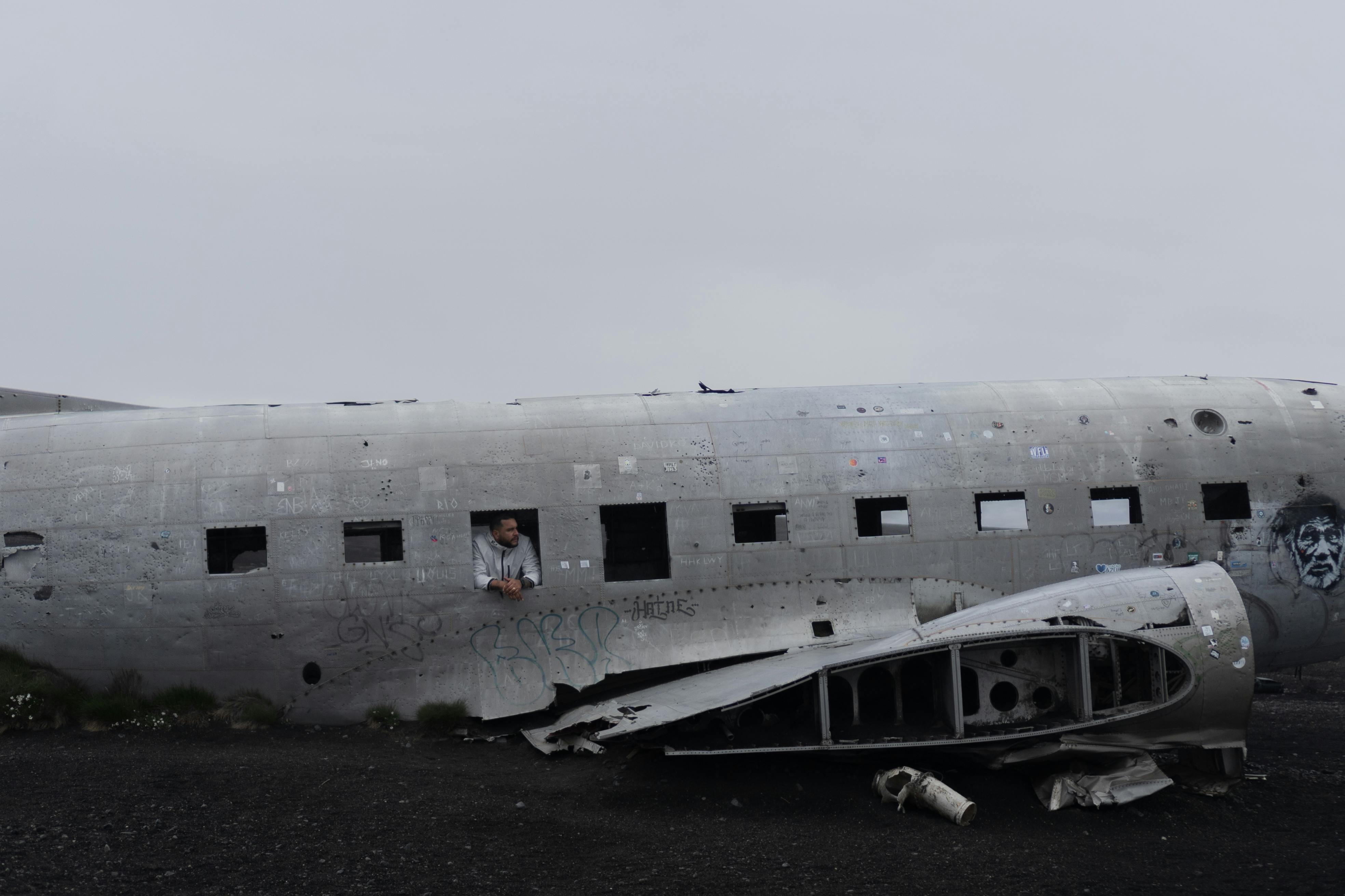 A Man Standing Inside the Solheimasandur Plane Wreck in Iceland