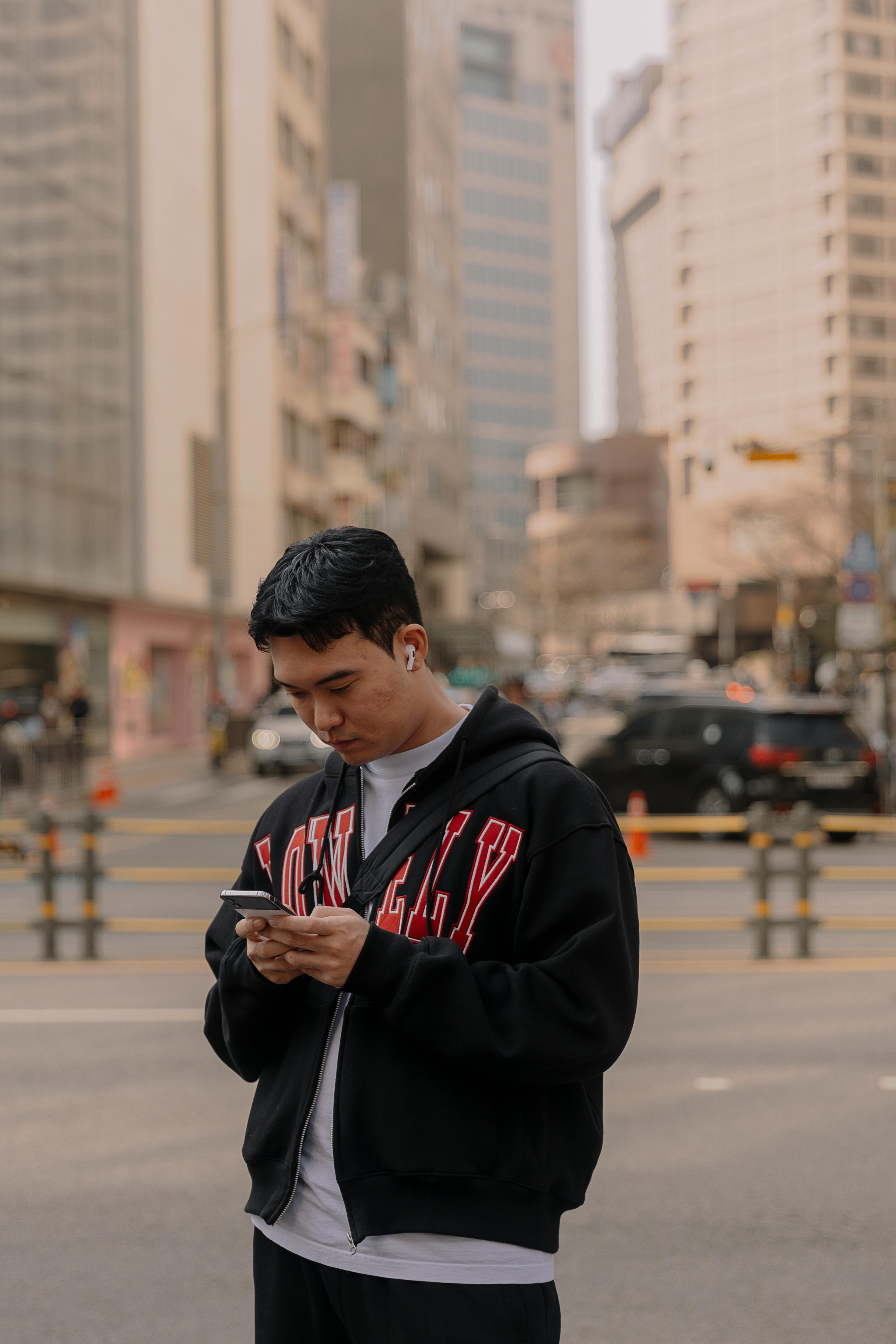 man using his phone on a street