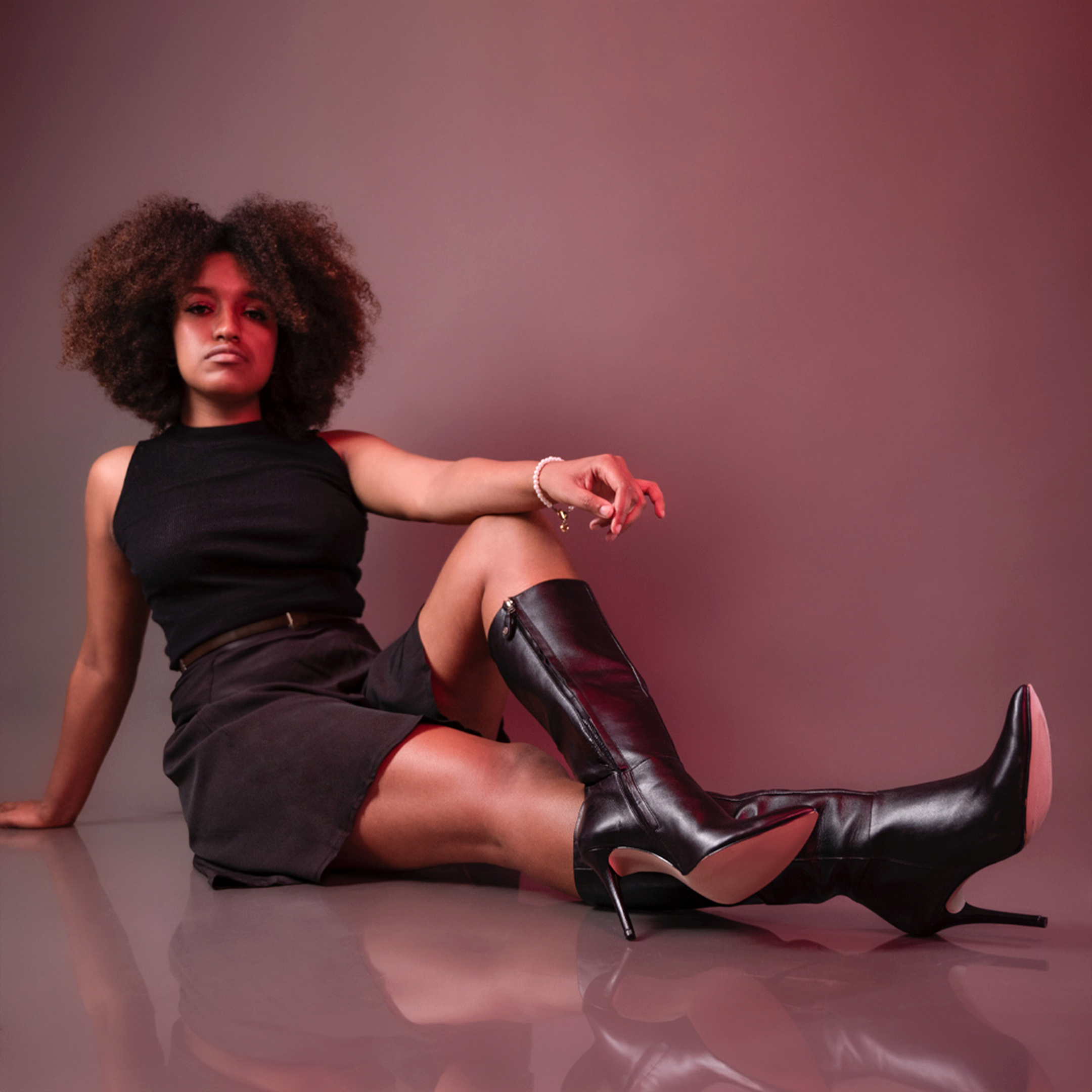 Studio Portrait of a Female Model Wearing a Skirt and Leather High ...