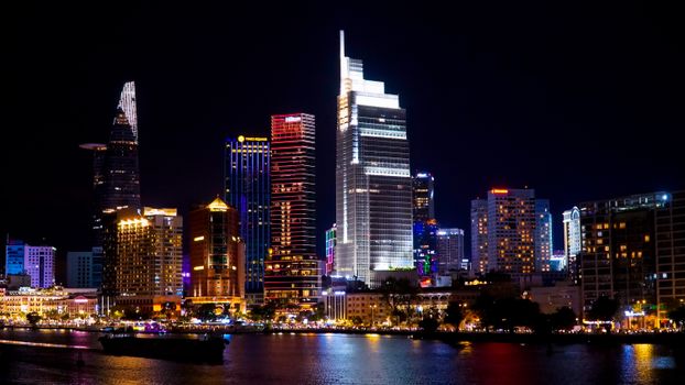 Stunning view of Ho Chi Minh City skyline illuminated against the night sky, showcasing modern architecture.