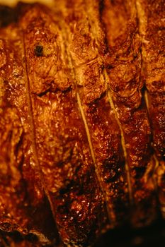 Delicious close-up of perfectly grilled meat showcasing its crispy, textured surface.