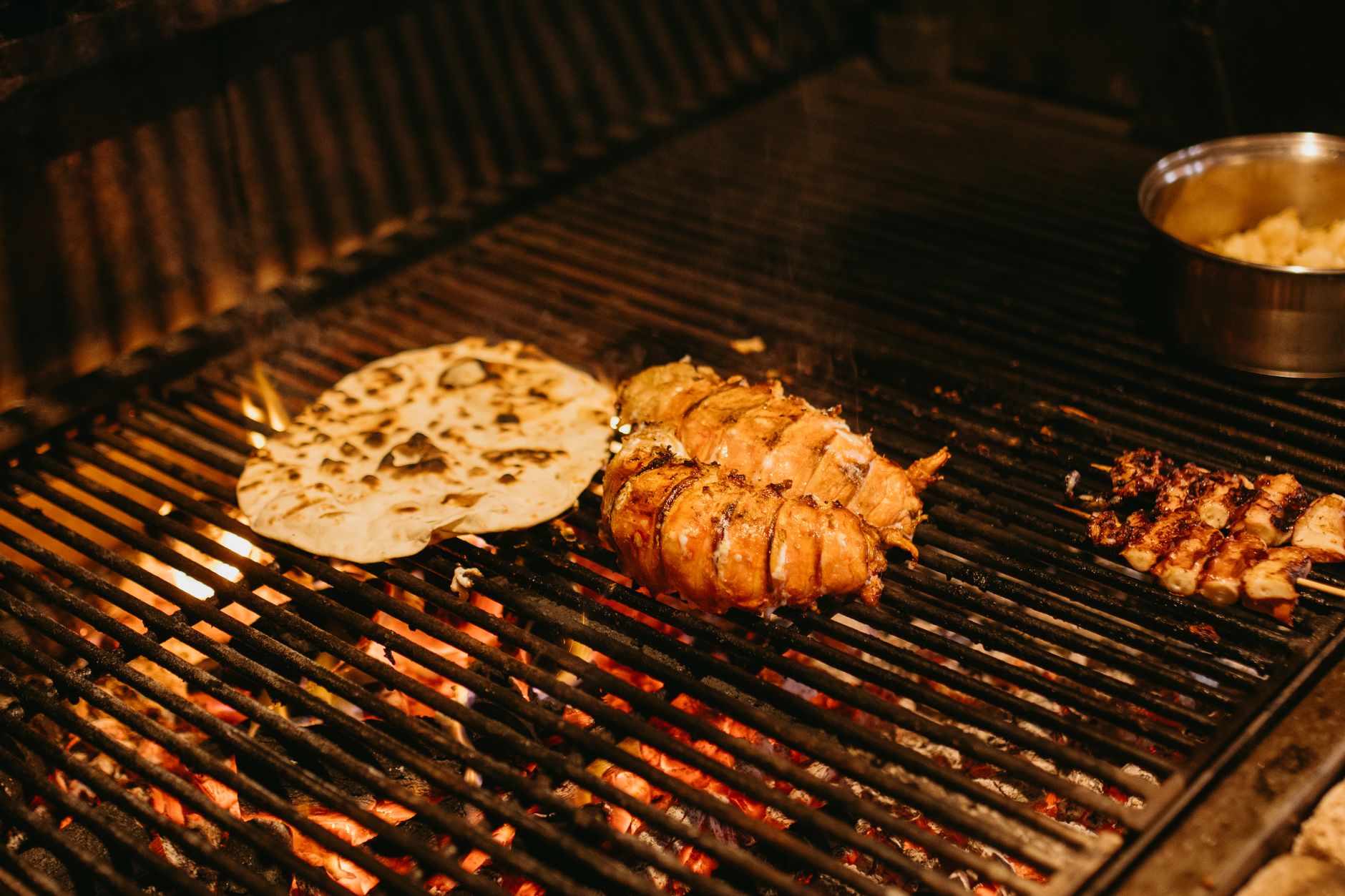Grilled pineapple and onion rings on barbecue