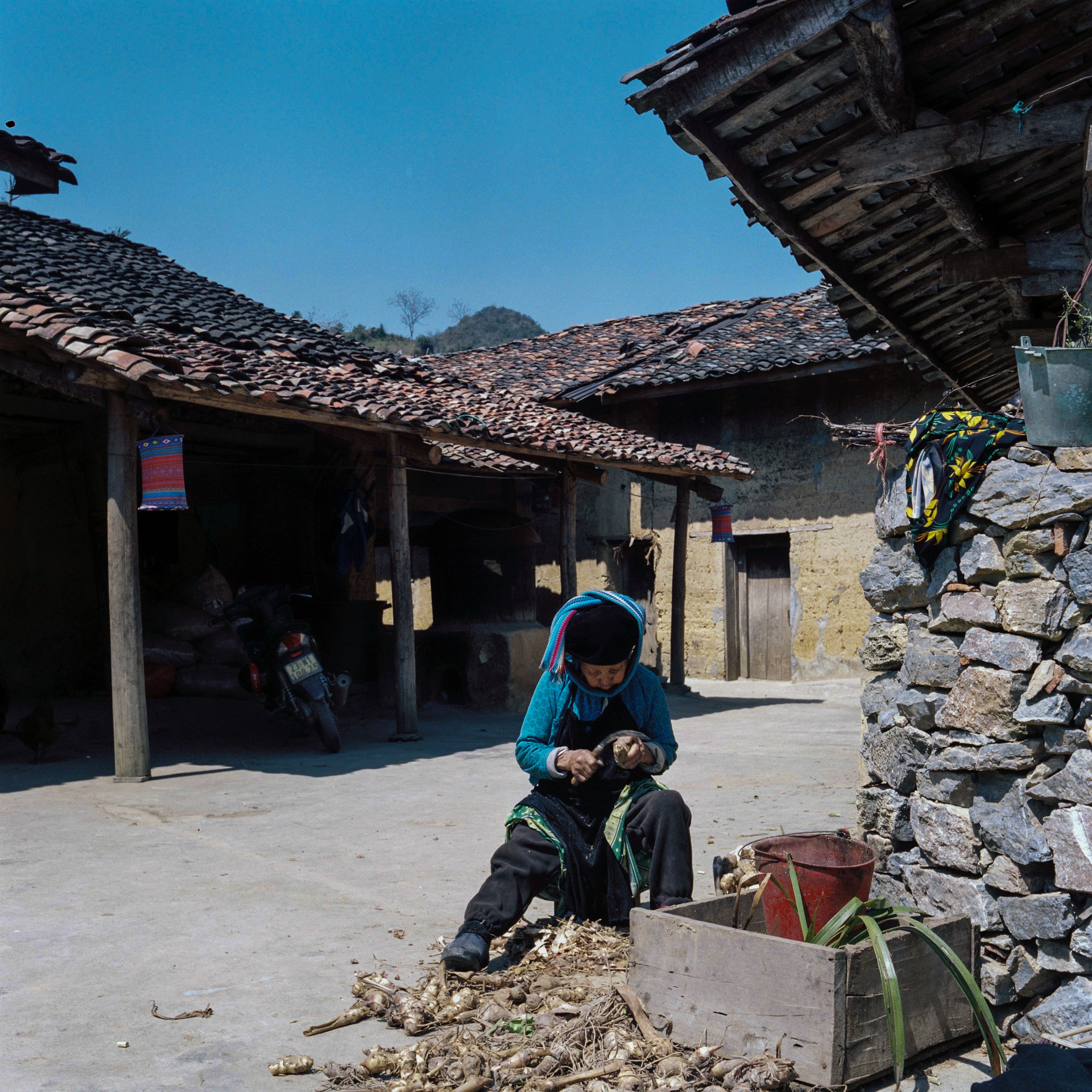 Person in Traditional Clothing Sitting in Village · Free Stock Photo