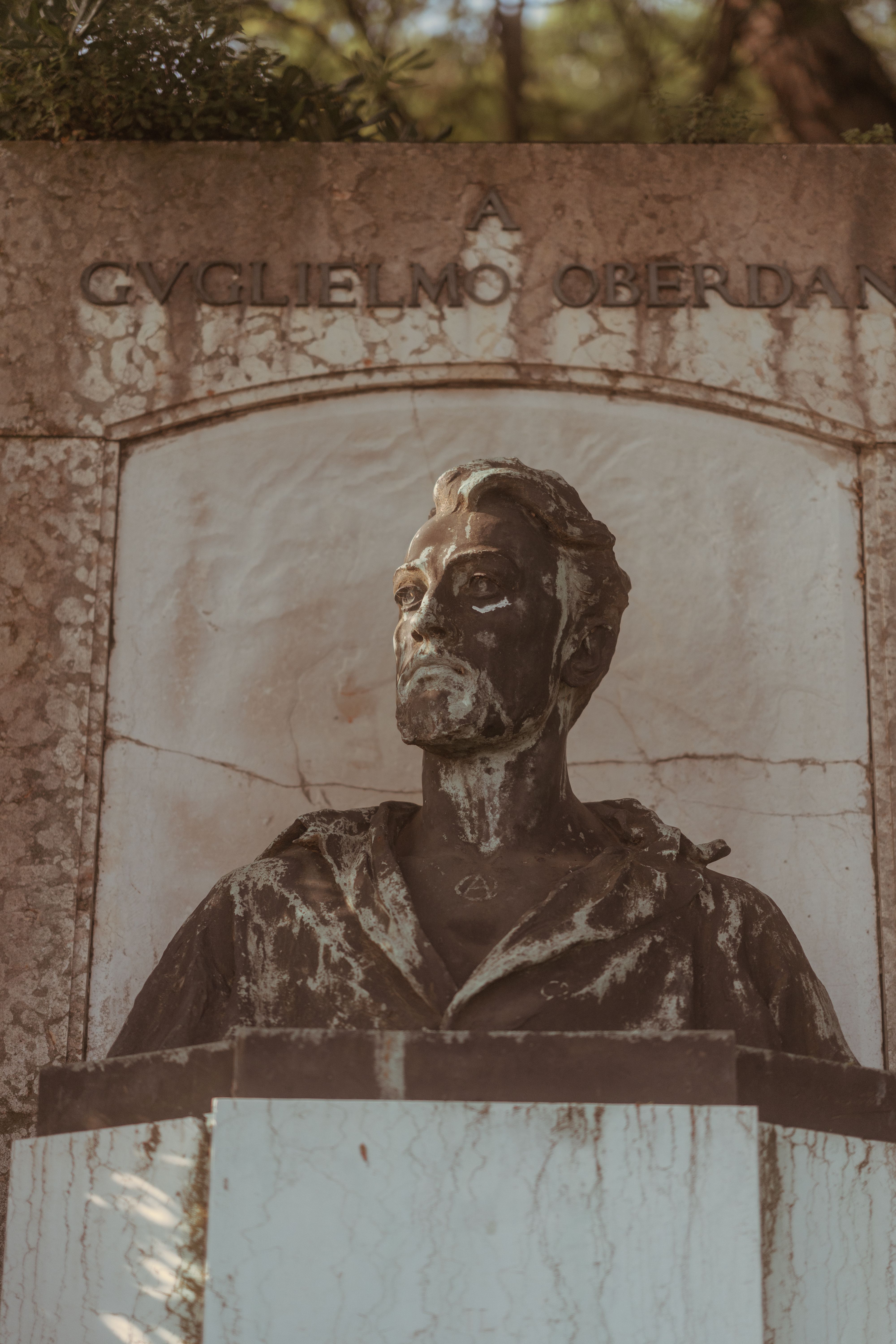 A marble bust of Guglielmo Oberdan located in a park in Venice, Italy.