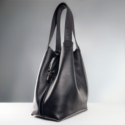 Black leather tote bag in a studio, photo by Jose Martin Segura Benites on Pexels