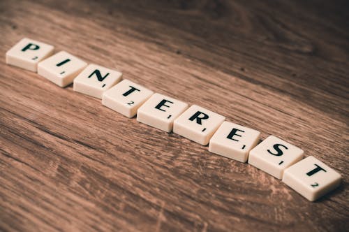 Scrabble Tiles Forming Pinterest Word on Brown Wooden Surface