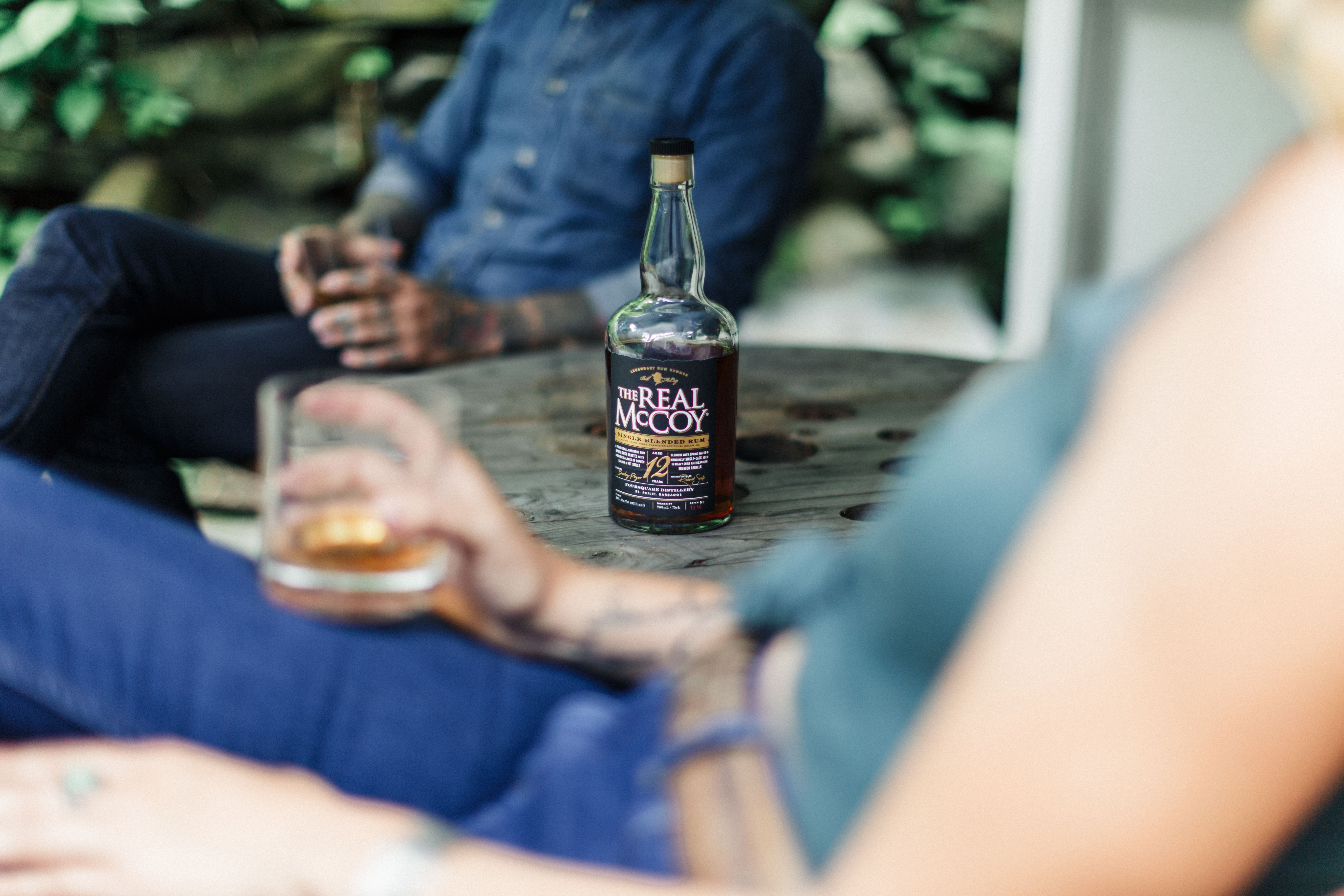 People Sitting at the Table in a Garden and Drinking Rum · Free Stock Photo