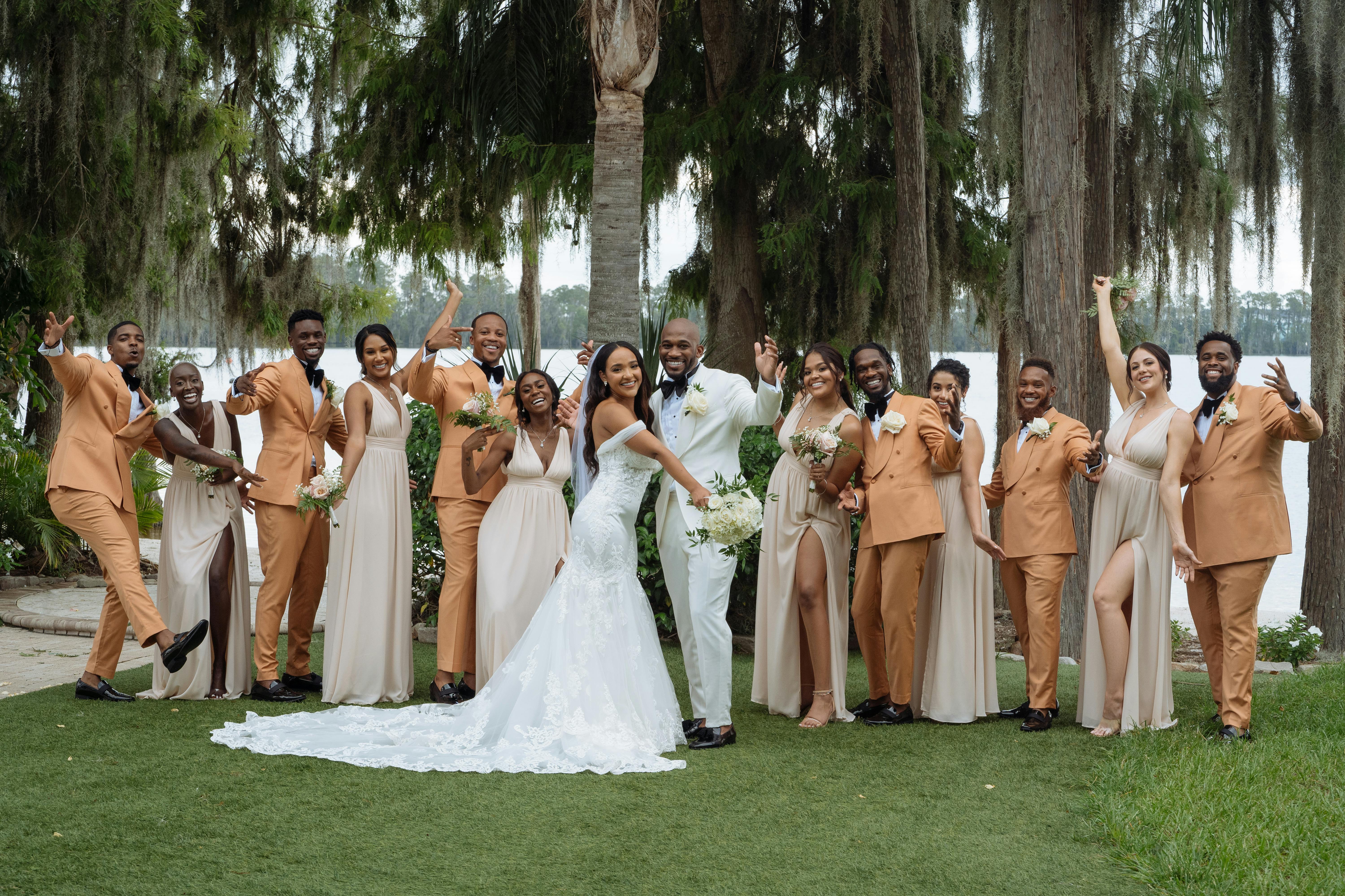 bride and groom posing with their best men and bridesmaids