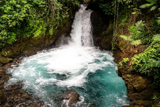 Explore this stunning waterfall in San Pedro Carchá, Guatemala, surrounded by lush green foliage.