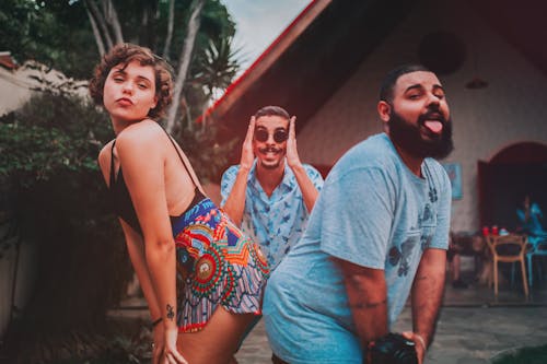 Three Men and Woman Taking Group Photo