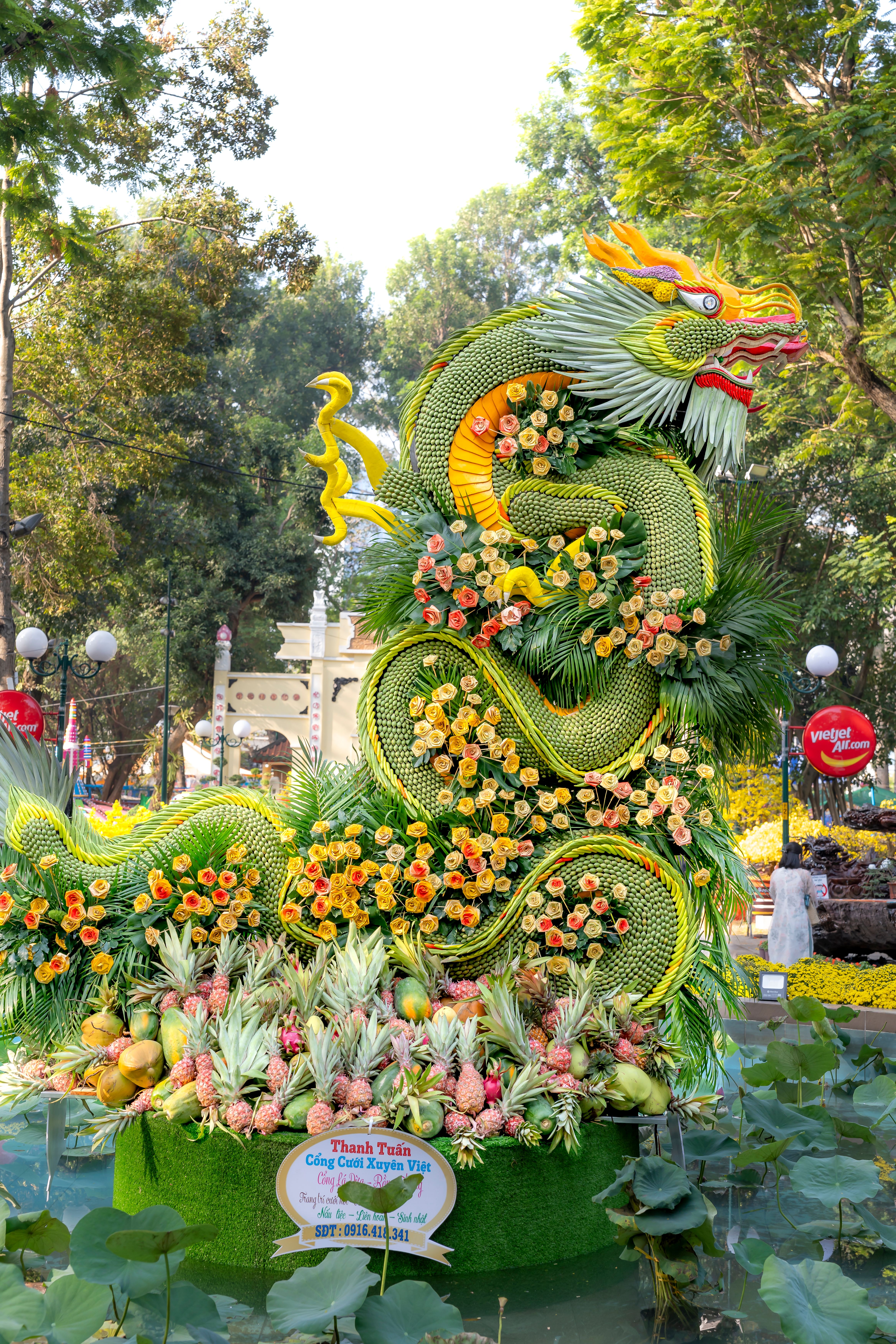 A Dragon Statue with Flowers in a Park · Free Stock Photo