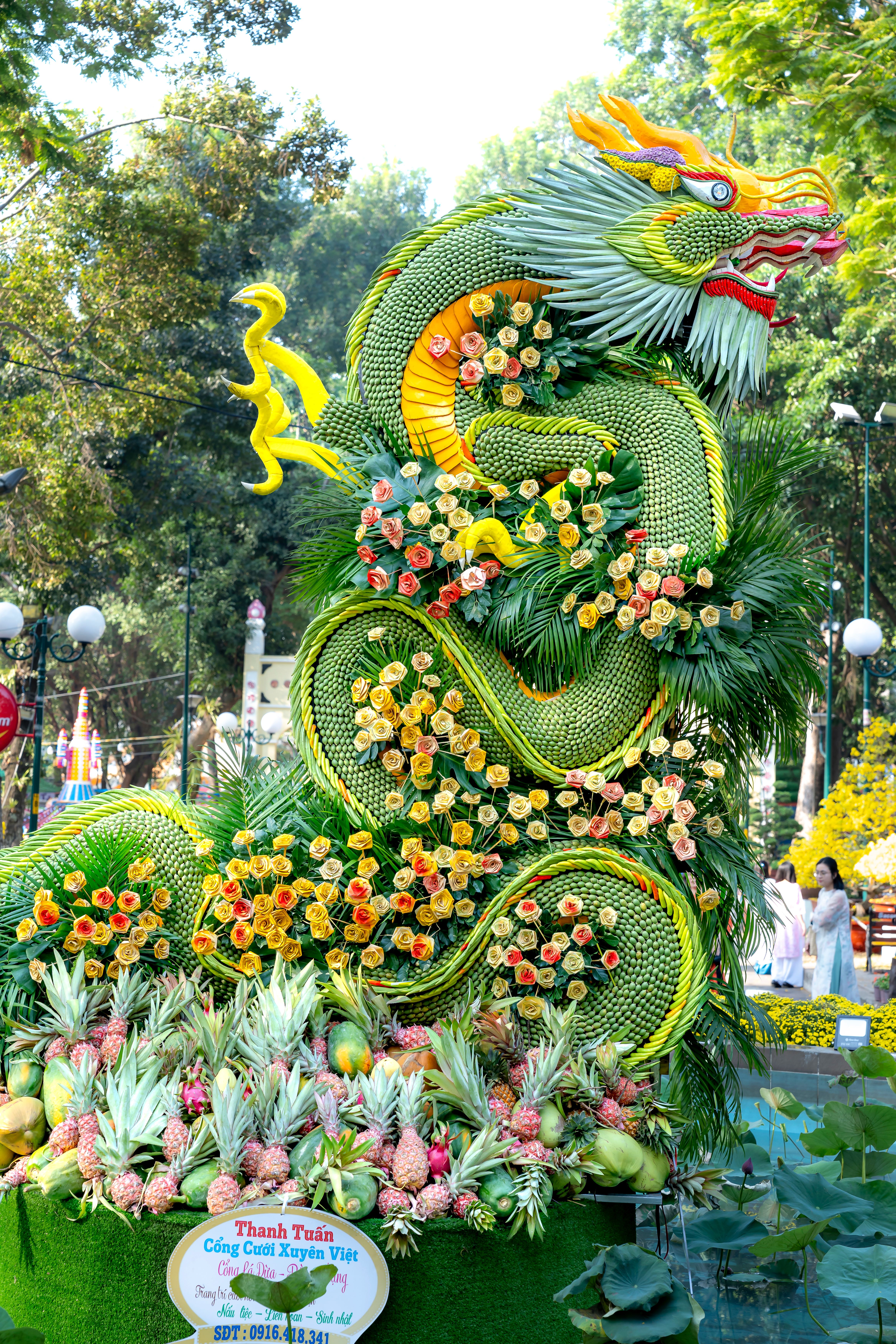 A Dragon Statue with Flowers in a Park · Free Stock Photo