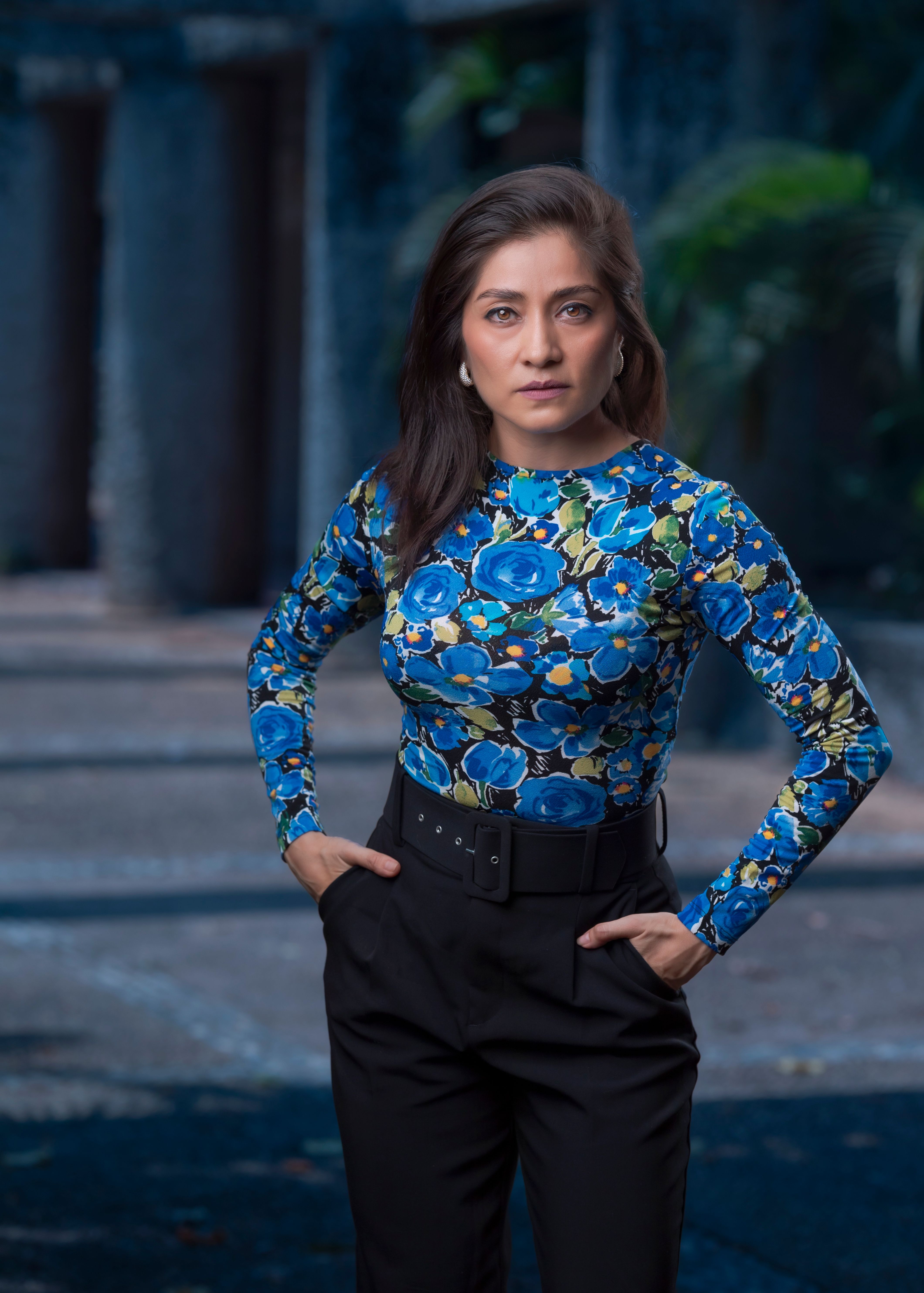 Beautiful Woman in a Blue Floral Shirt Posing · Free Stock Photo
